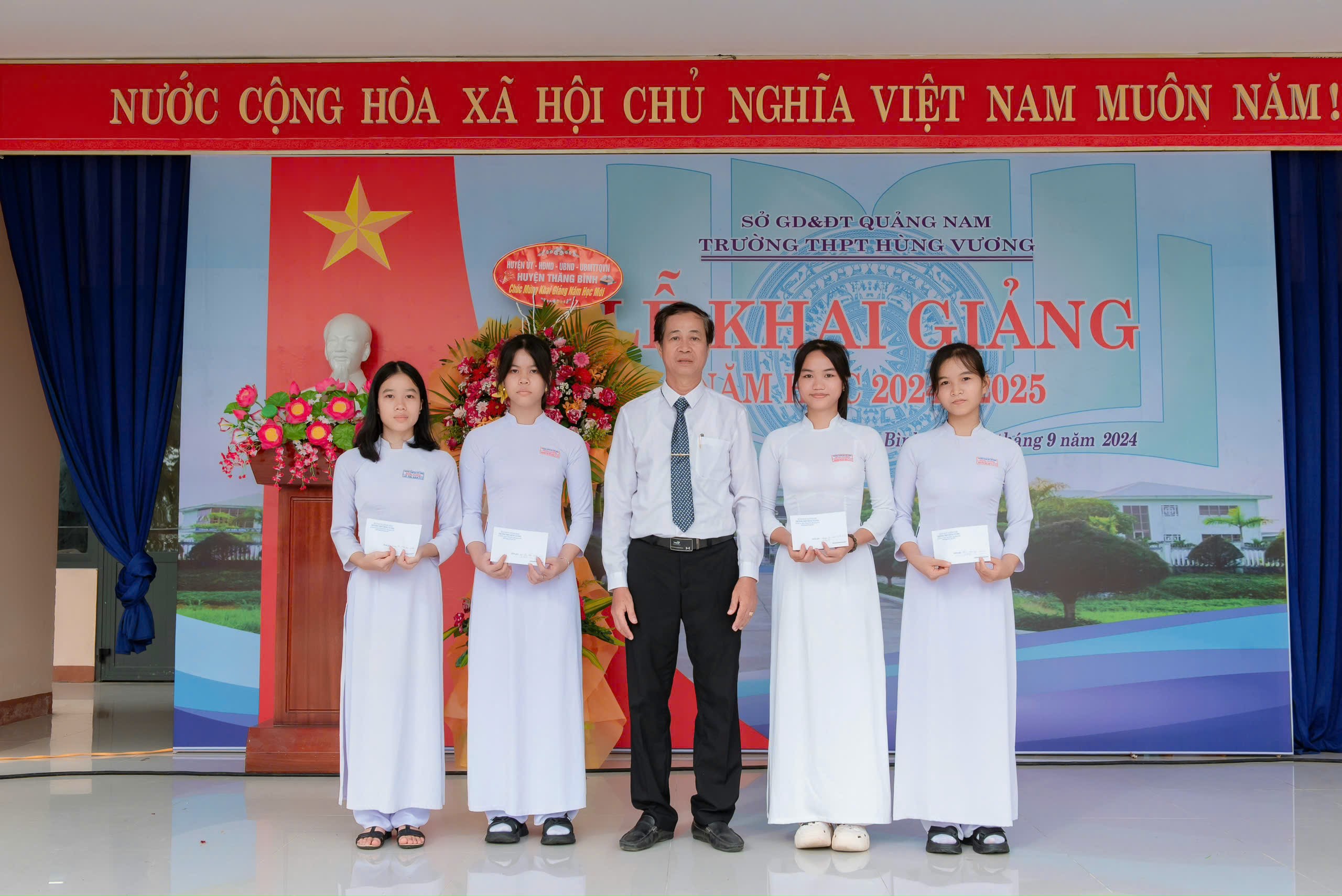 students are lining up with certificates of merit in front of their classroom