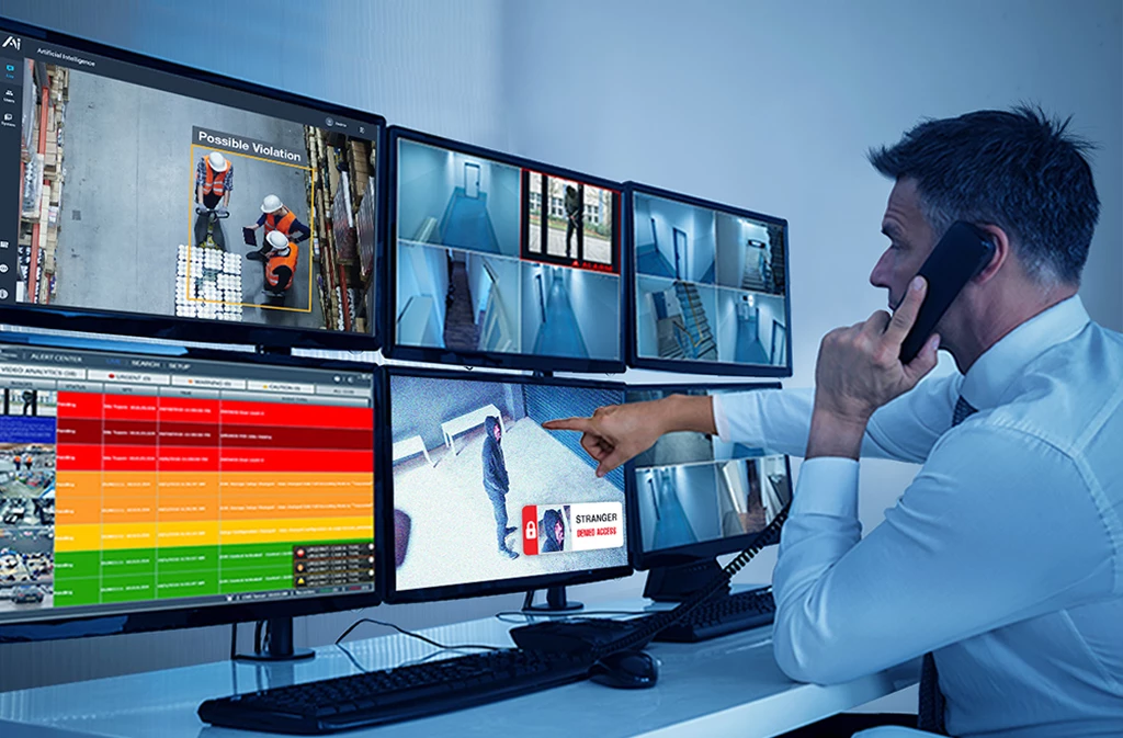 Security operator monitoring alerts on multiple screens