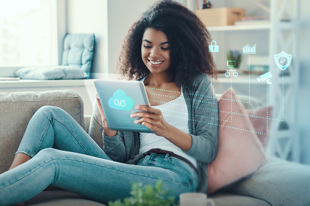 A girl sits on a chair using CMS on her device