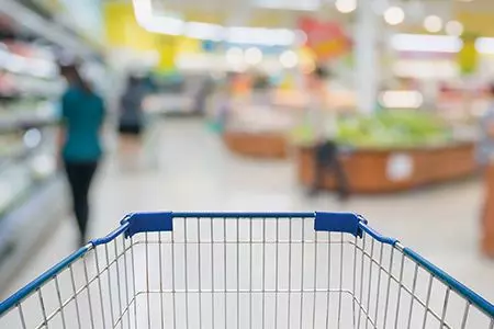 Empty shopping cart in grocery store