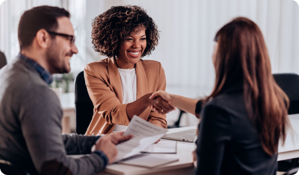 Business meeting with handshake and documents on table