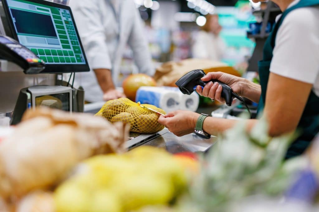 Grocery Store Checkout with Clerk Scanning Items
