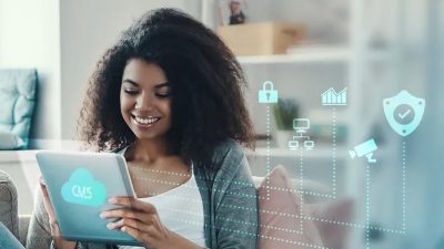 Person holding a tablet displaying CMS cloud icons and security graphics