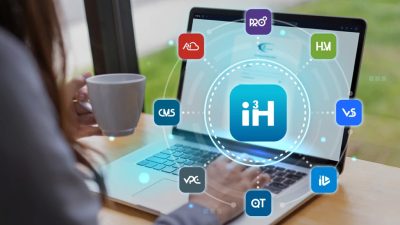 Person working on a laptop with i3Host icons displayed