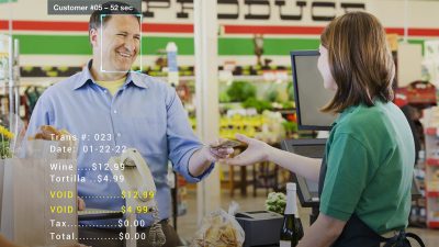 Customer paying at a convenience store checkout with groceries and receipt details displayed